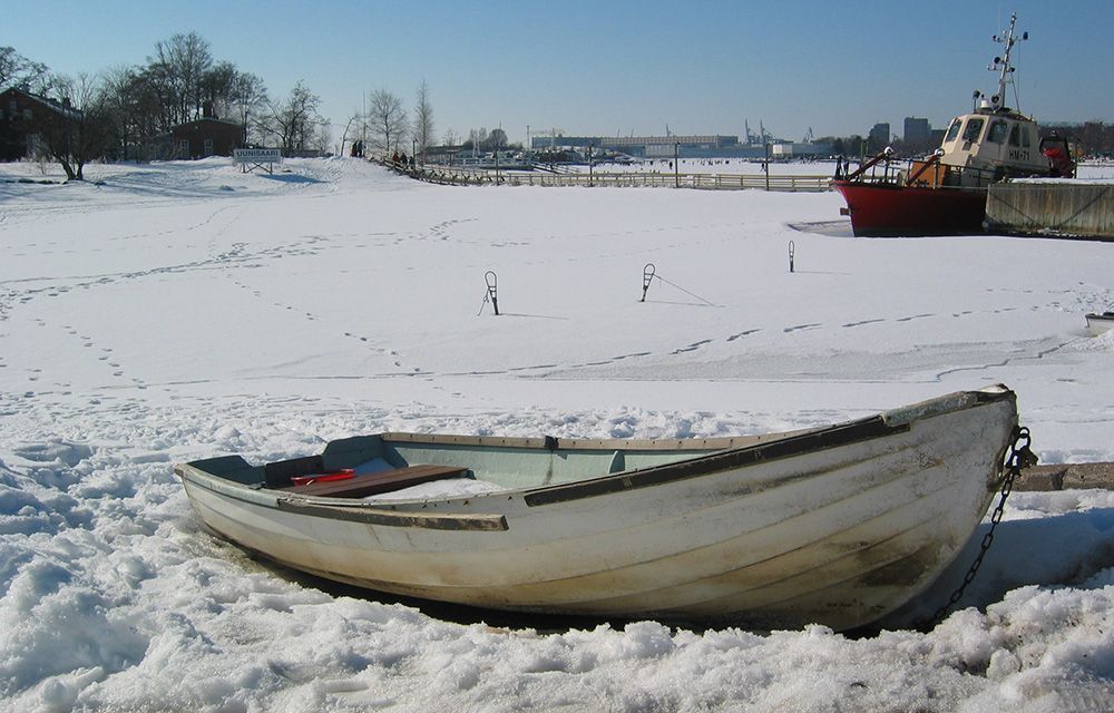 rowing boat on a frozen sea in Helsinki, Finland