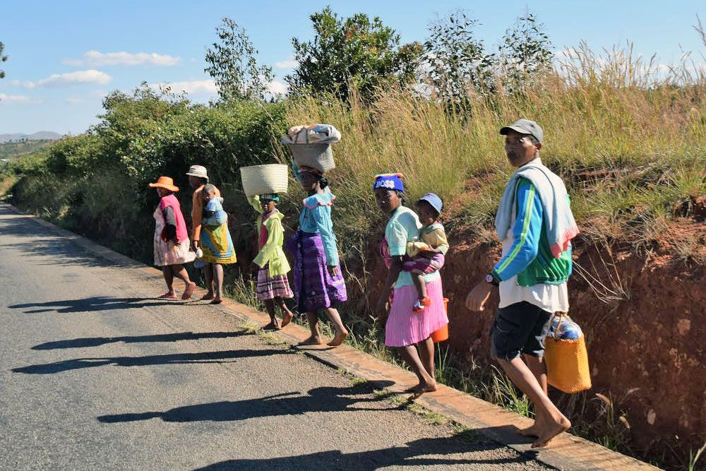 Family walking towards village