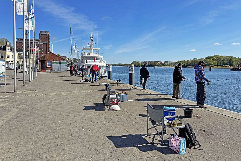 Fishermen at the boulevard in Kappeln, Schleswig-Holstein